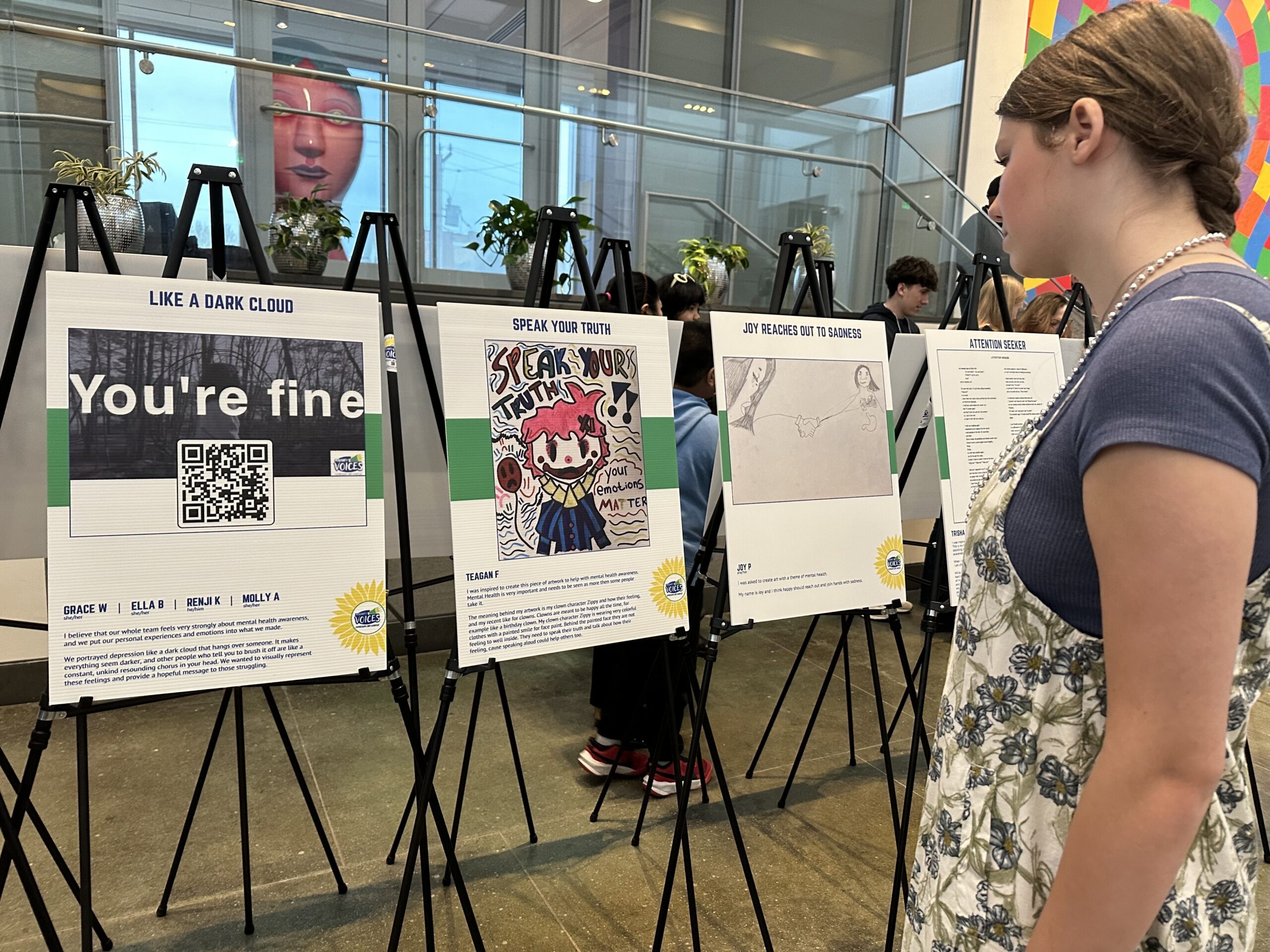 young girl looking at art exhibit